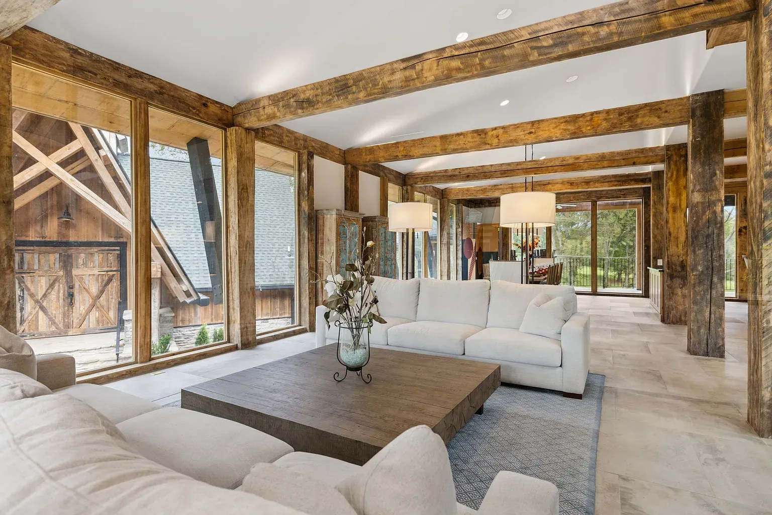 Beams overhead, glass walls all around. The forest is basically your wallpaper.