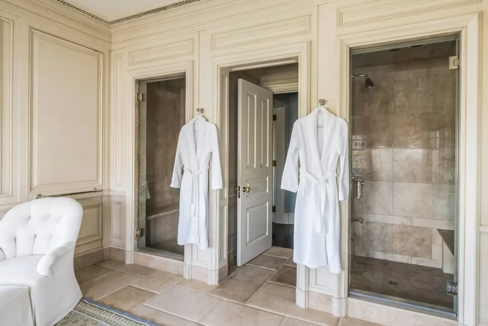 Cream paneling everywhere. Feels a fancy hotel bath. Sconces are doing work.