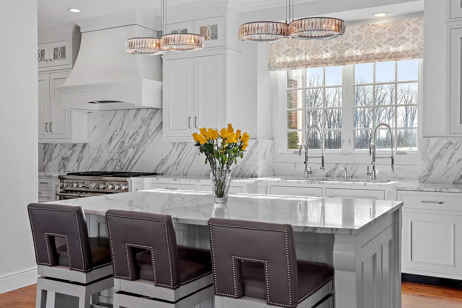 White-on-white kitchen with a huge marble island. I’d actually cook here.