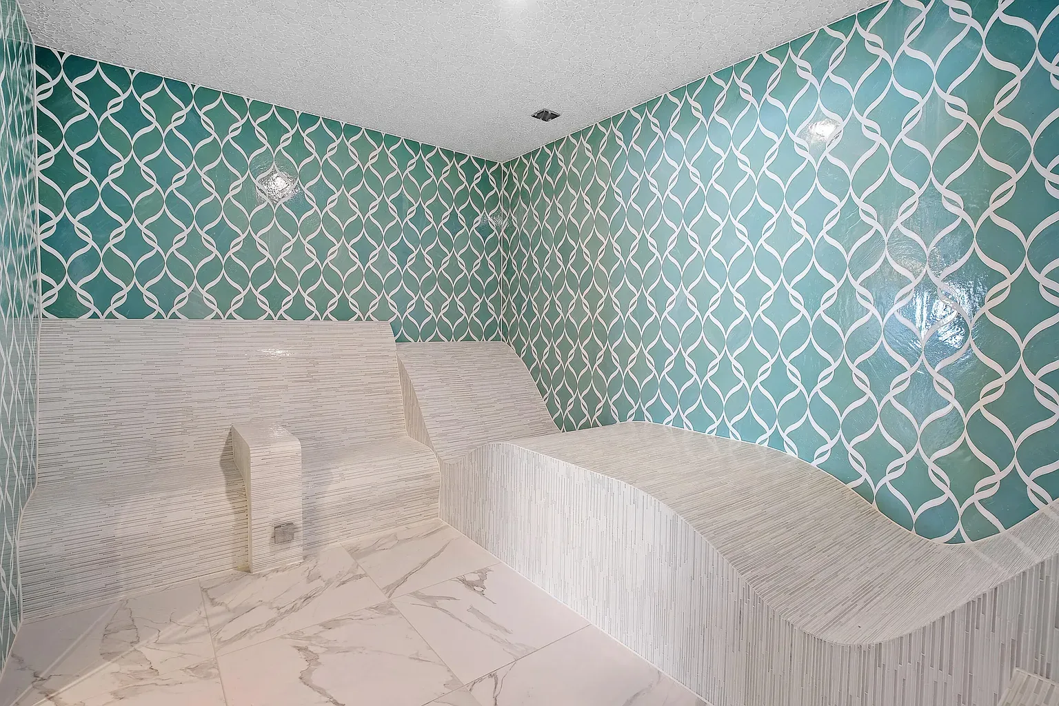 Teal geometric wall is doing the most, and I’m not mad.