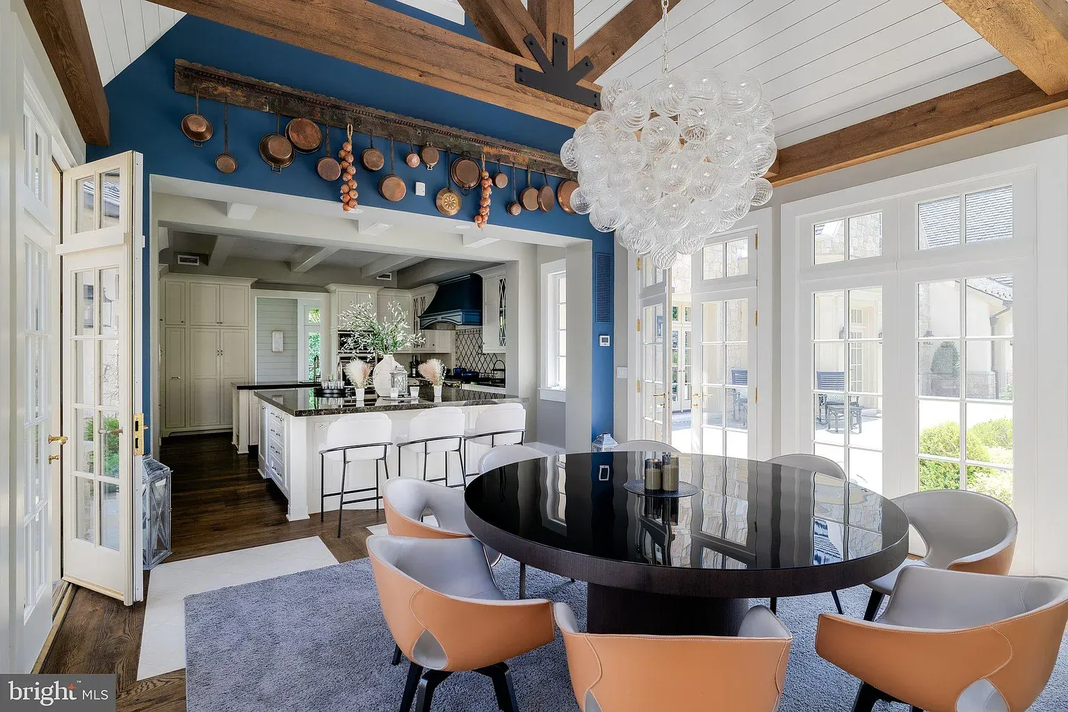 Round black table, creamy chairs, bubble chandelier. Cute, kind of glam.