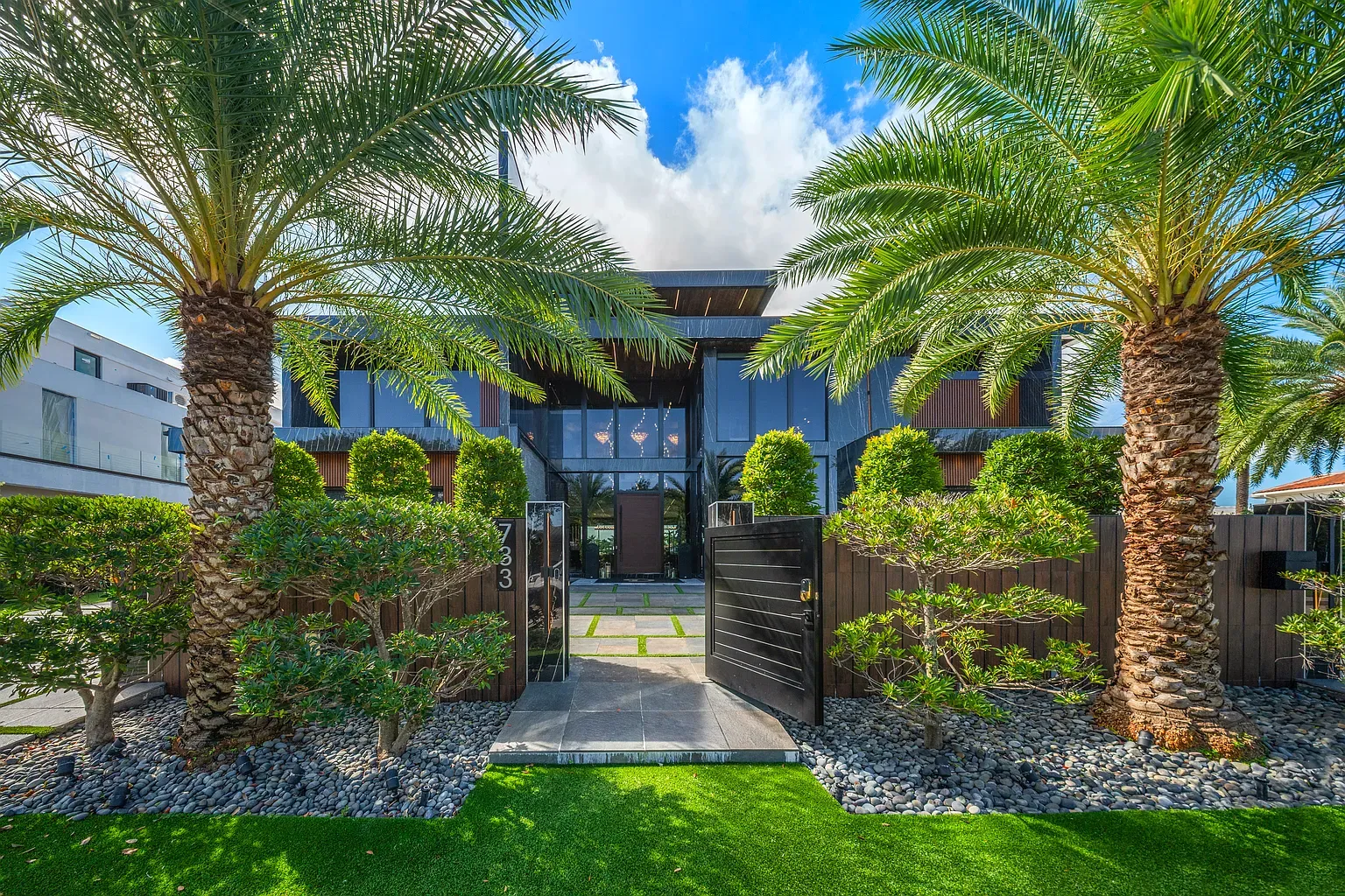 Final exterior shot. lots of glass, sharp lines, palms doing their thing.