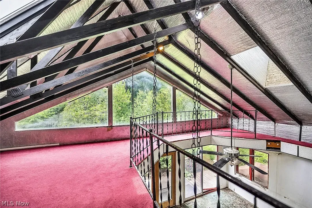 A-frame loft with soaring beams and thick carpet. Echoey in the best way.