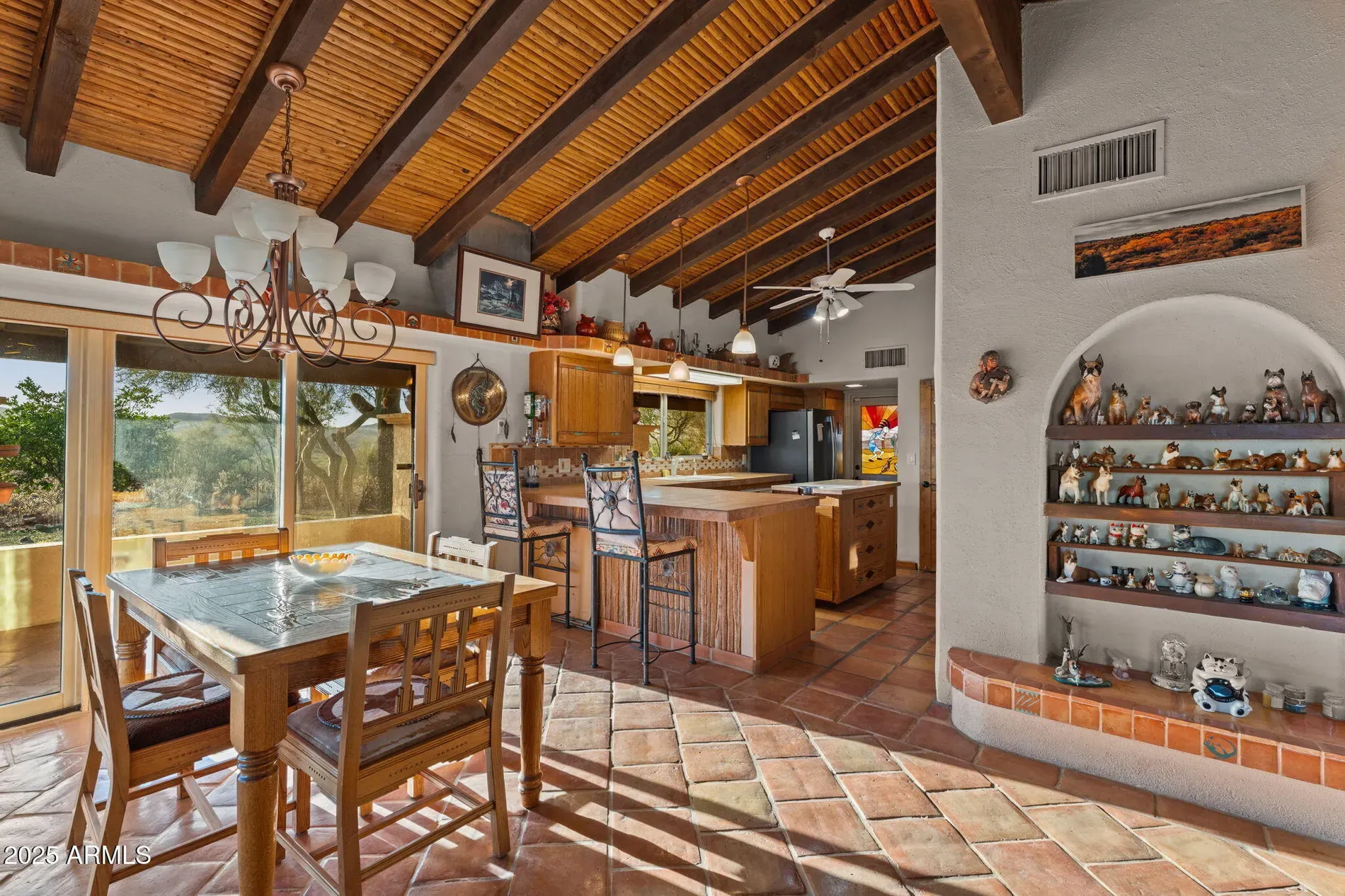 Open kitchen/dining, same tile flows through. Beams tie it together.
