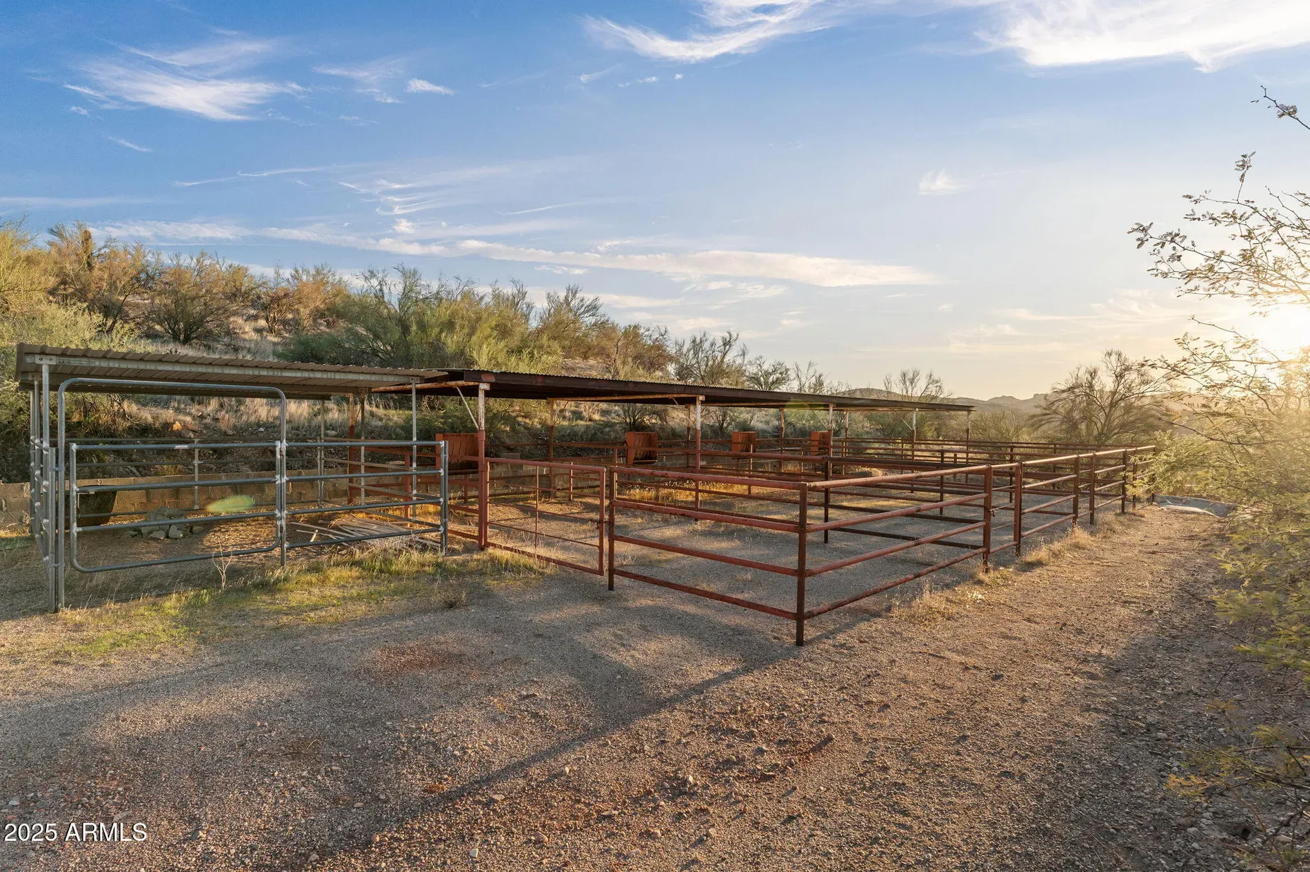 Oh, legit livestock pens out back. Weathered red metal, very practical.