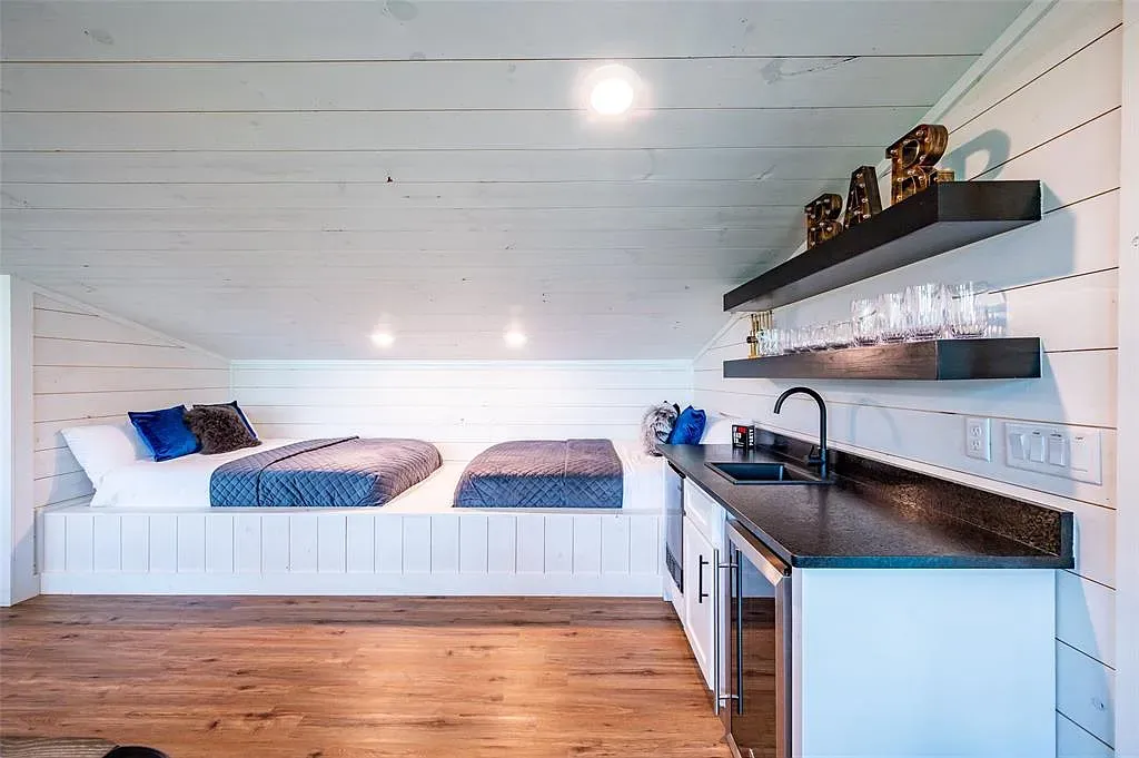 Loft with shiplap and warm floors. Feels airy. Two neatly made setups.