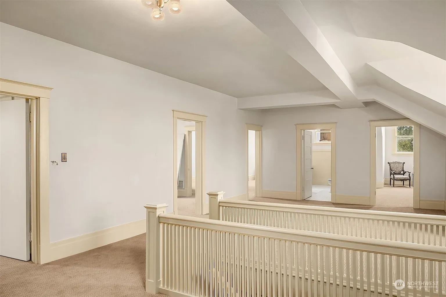 Upstairs hallway is soft and bright. Creamy walls, lots of breathing room.