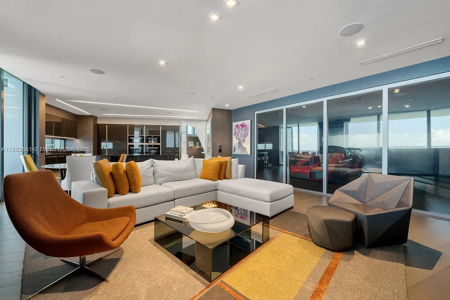 From the corner, this living room feels bigger. Neutrals, view doing the talking.