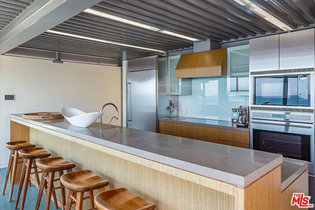 Concrete island slab for days. wood stools keep it from feeling cold.