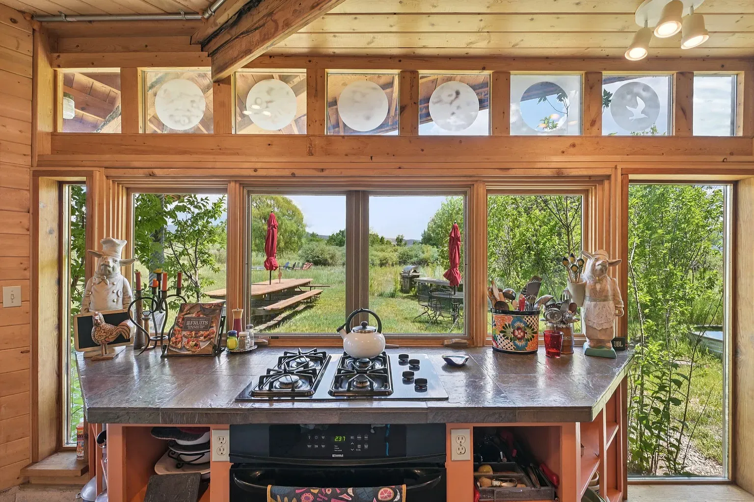 Dark granite meets light cabinets. Solid work triangle, cozy ceiling beams overhead.