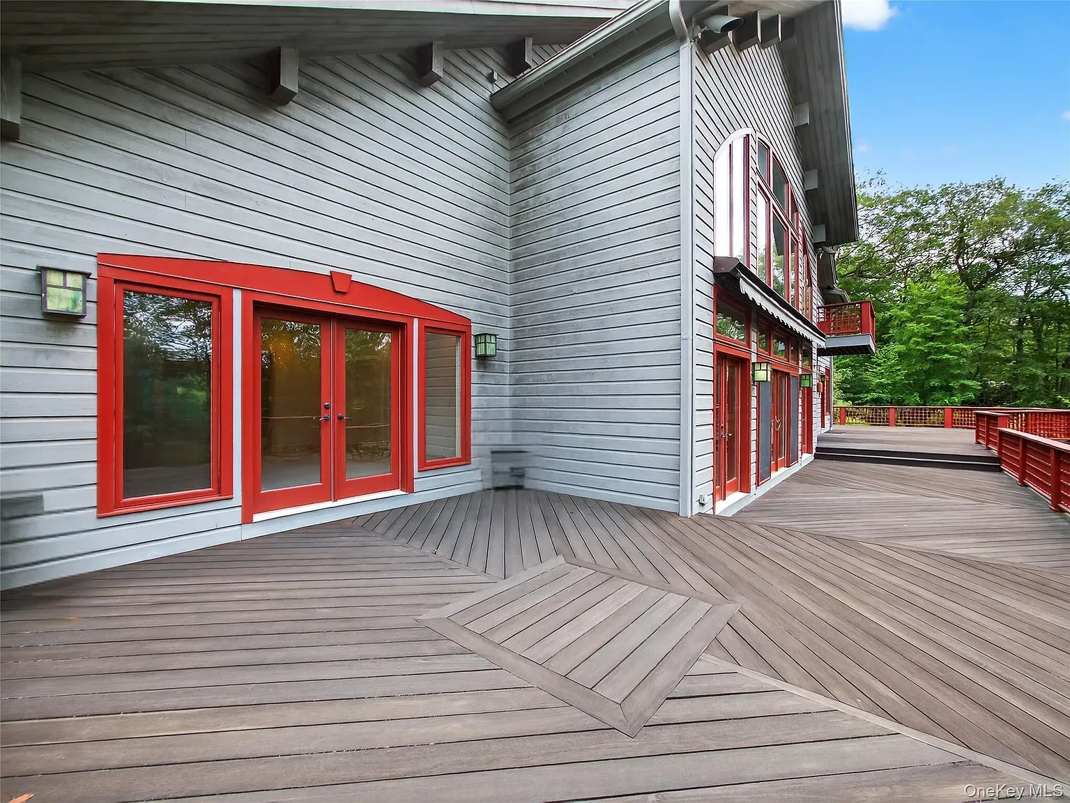 That herringbone deck pattern is flexing. Looks great against the gray siding.