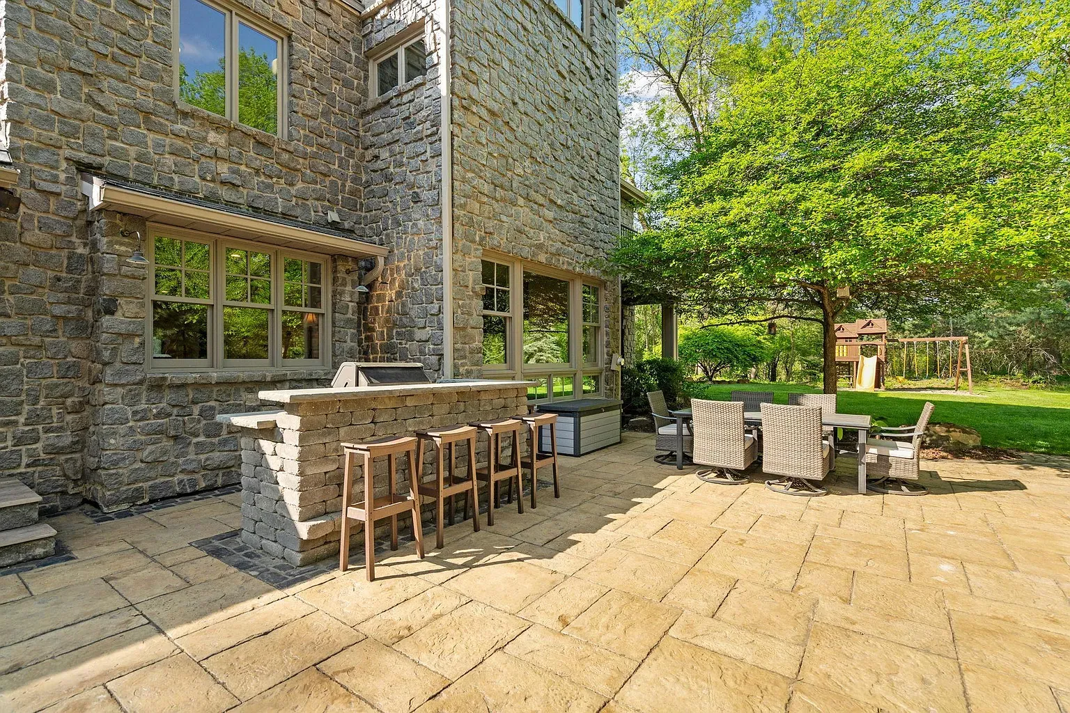Stone patio plus an outdoor kitchen - party spot locked in.