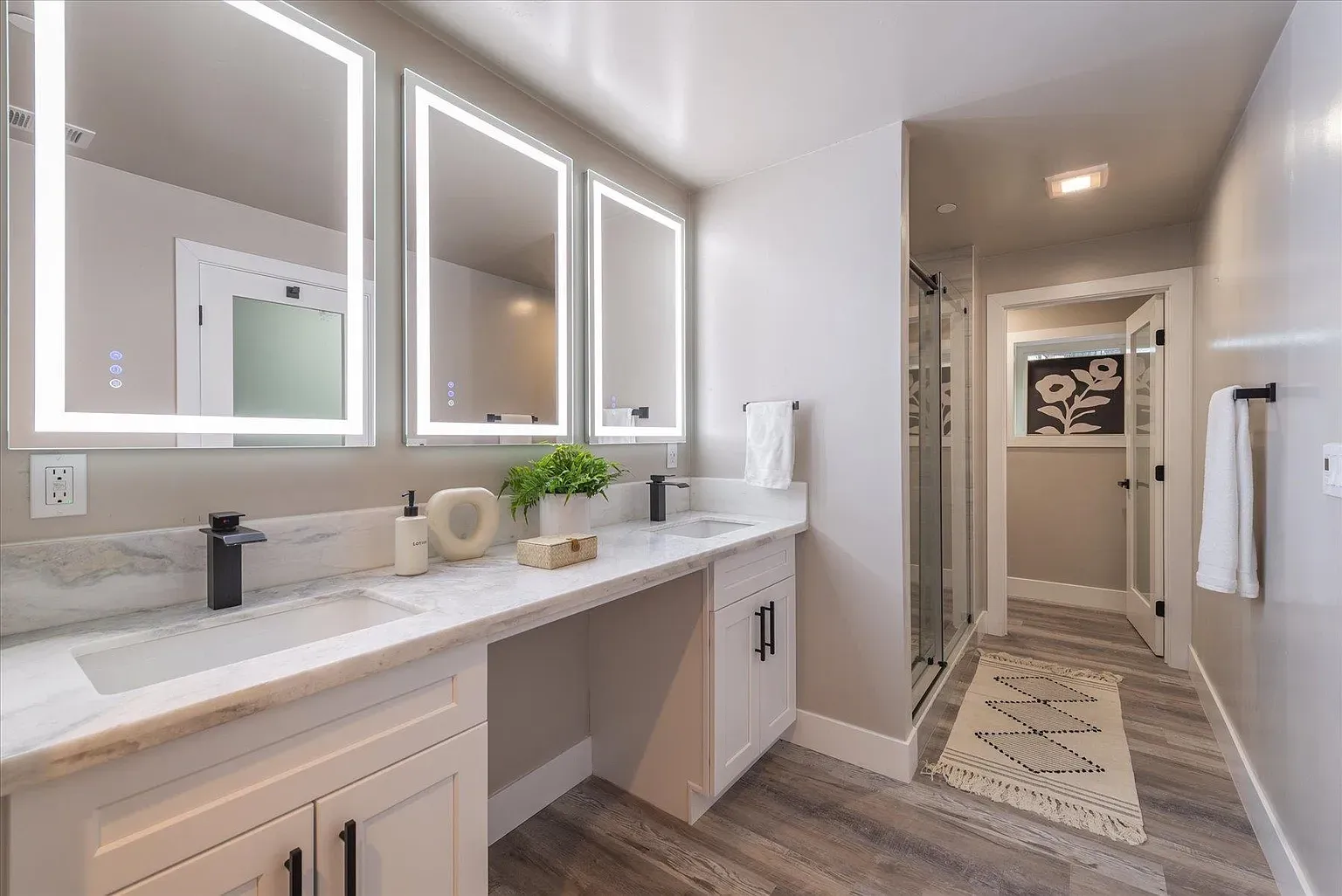Double vanity with marble and black hardware. Clean, hotel-level nice.