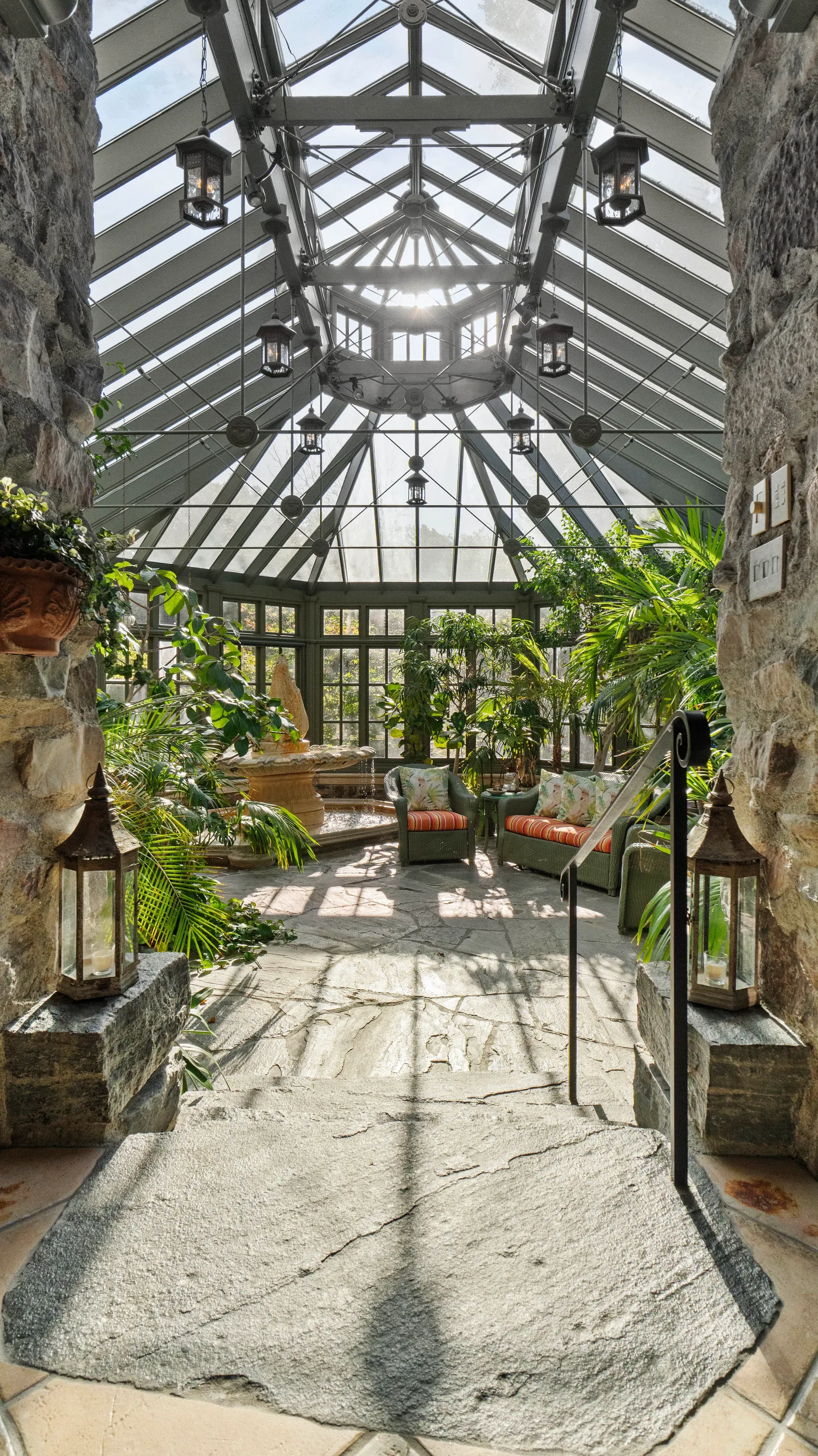 Stone-walled conservatory under a glass vault. Rain sounds would be amazing.