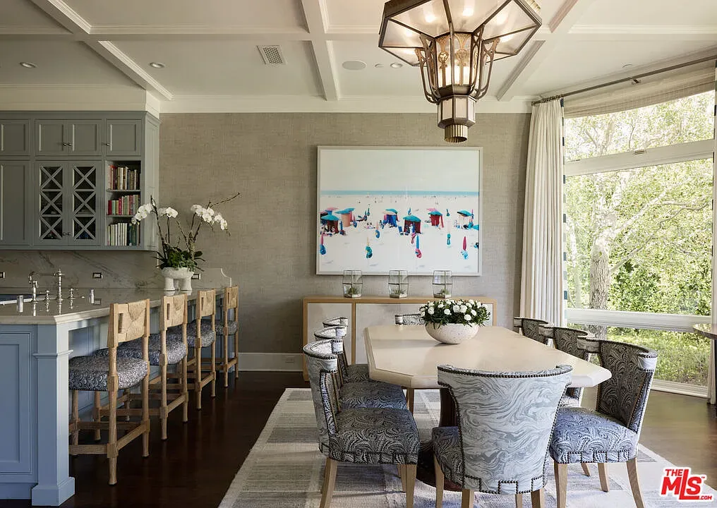Dining room with a big curved window. Light just pours in.