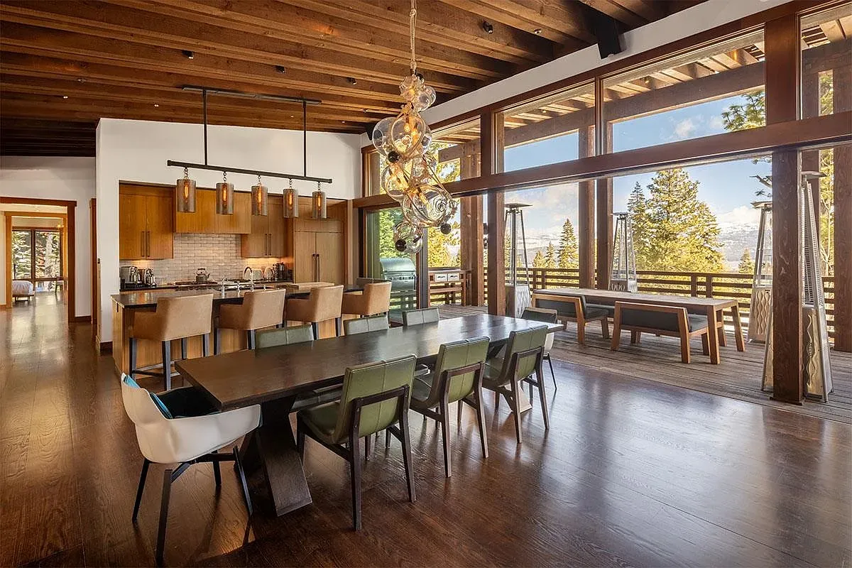 Long dark table, mixed chairs, colorful pops, and the pendant lights absolutely make it.