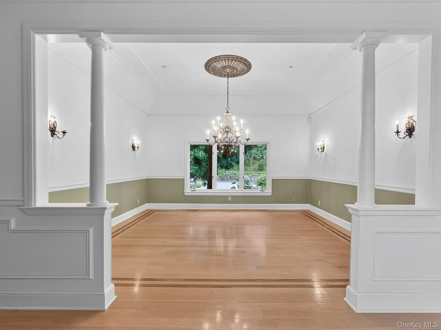 Dining room is calm. White walls, green accents, big windows.
