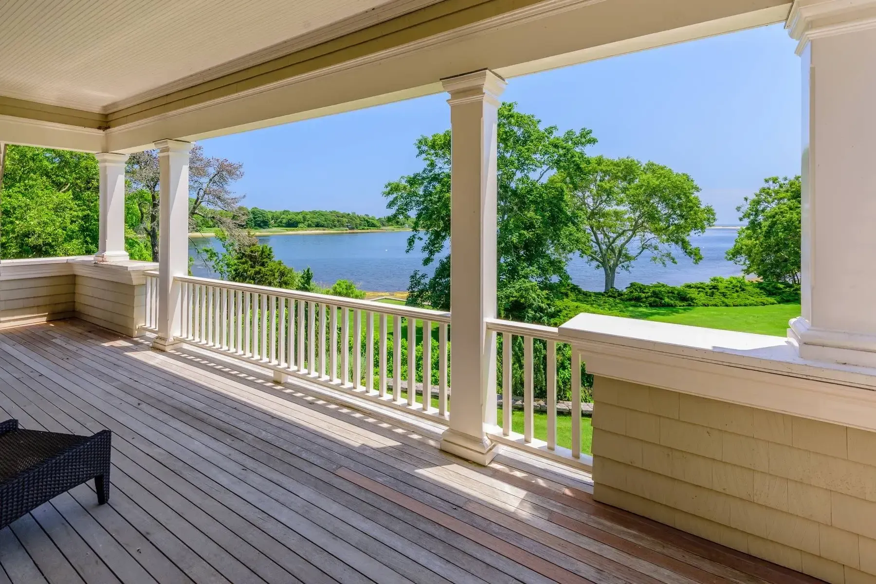 Long porch with six columns. Rocking chairs needed. Summer thunderstorm hangout.