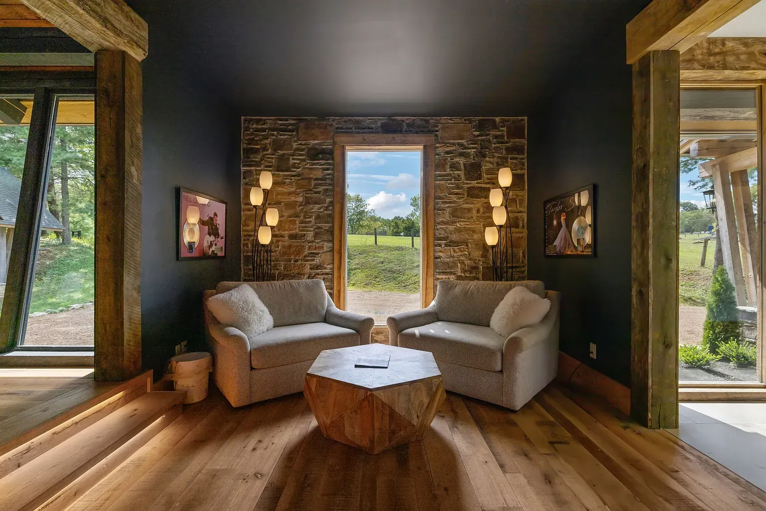 Cozy corner with dark walls and giant windows staring straight at the trees.