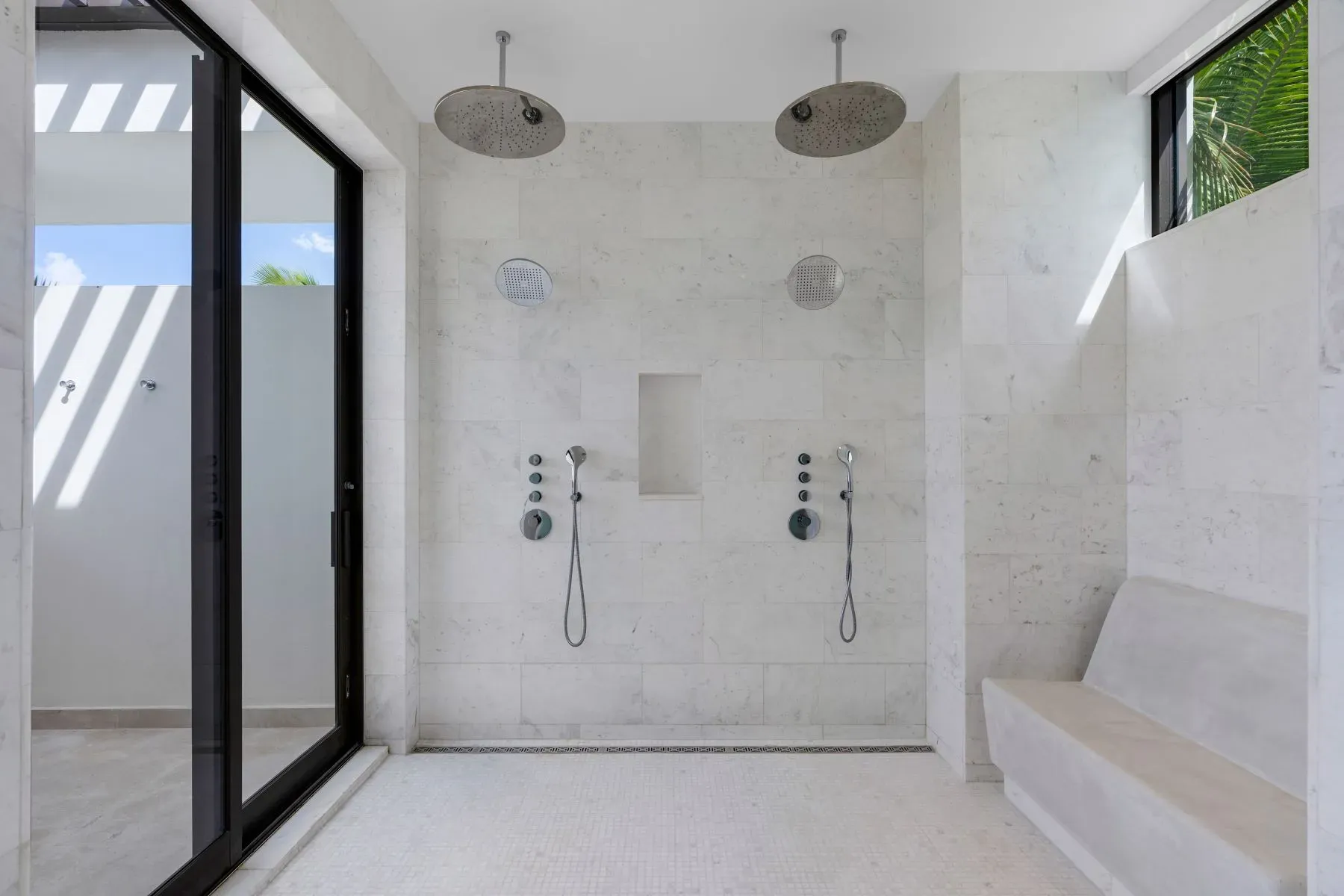 Spa bathroom moment. creamy marble everywhere, clean lines, soft light.