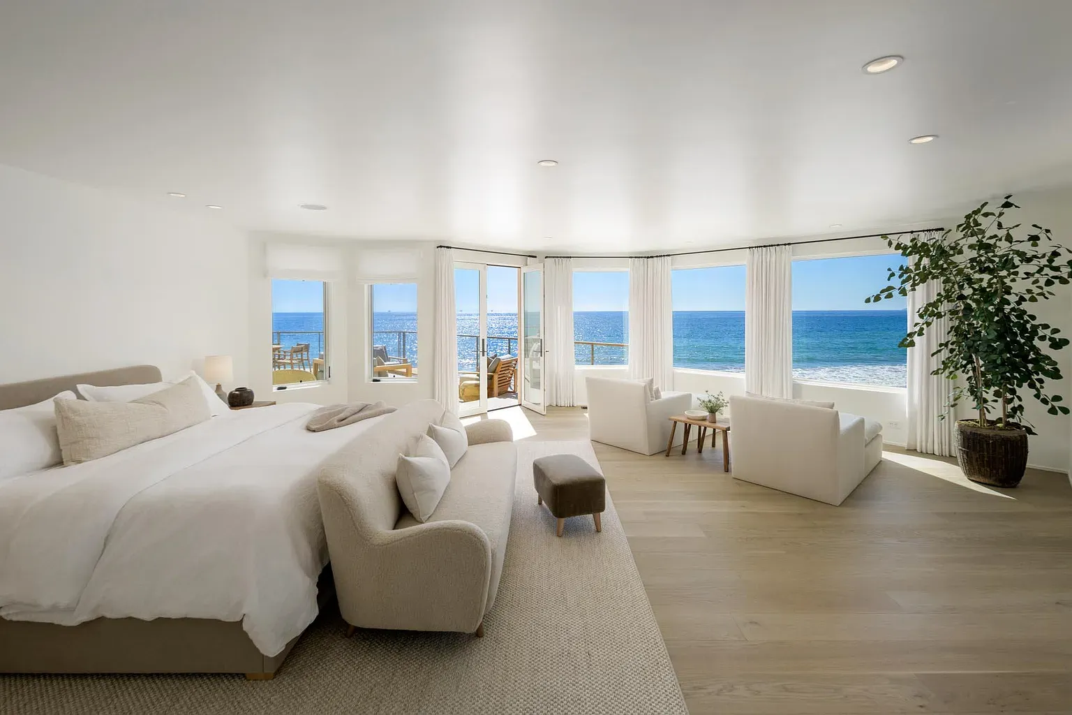 Bed facing nothing but ocean. Waking up here would ruin alarms forever.