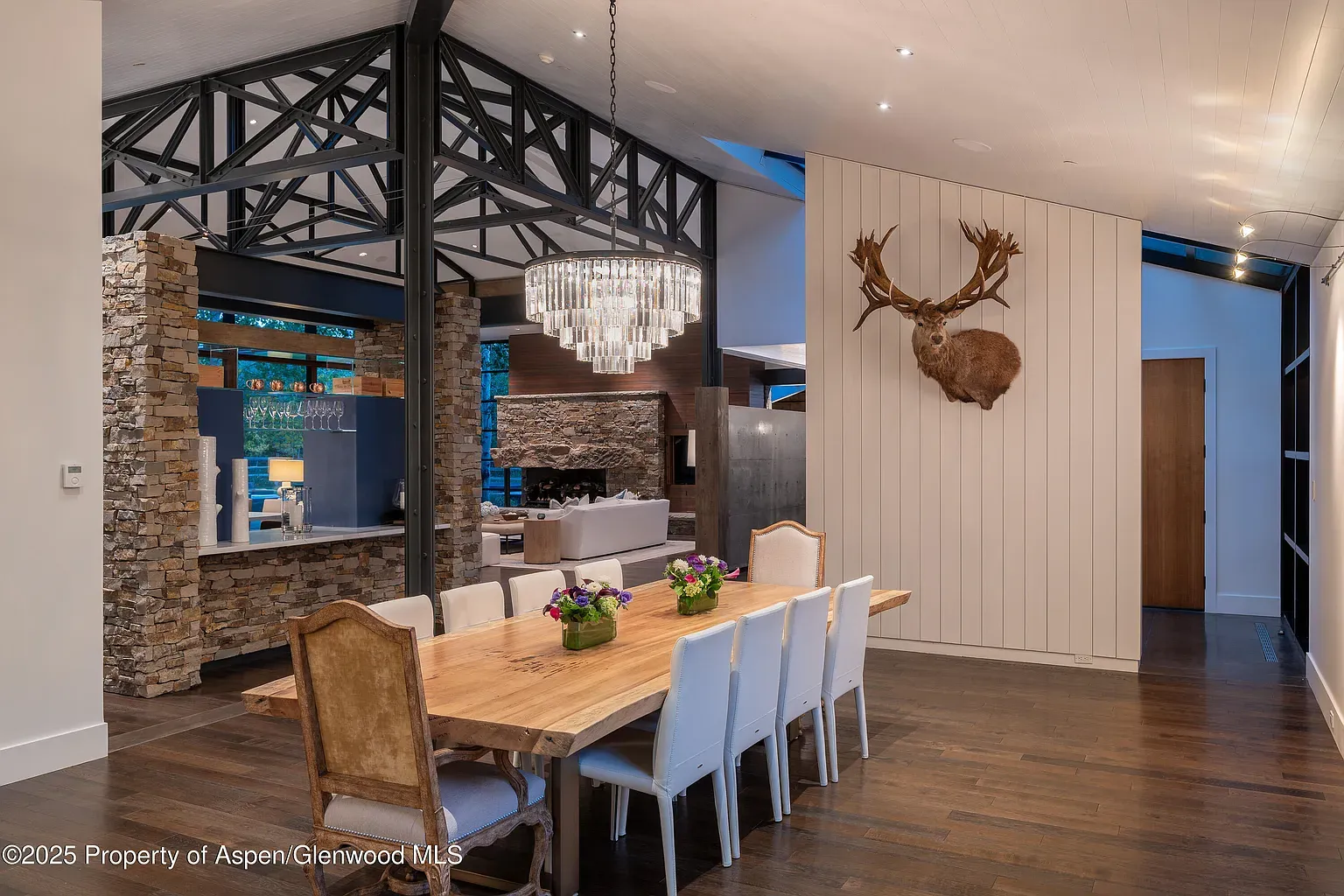 Long wood dining table, cushy chairs, warm lighting. Dinner parties solved.