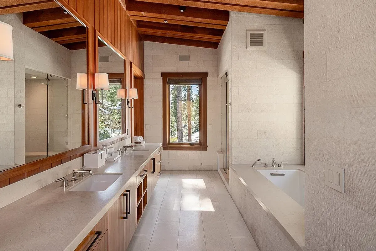 Big window by the tub, natural light everywhere. Rustic-modern done right.