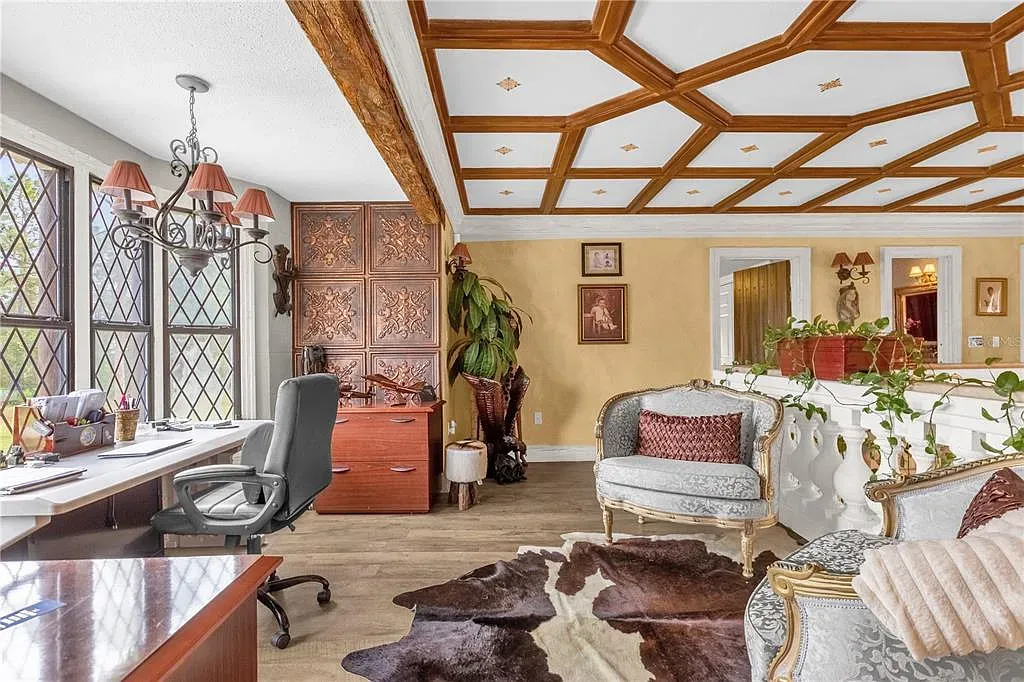 Coffered ceiling doing the heavy lifting. Golden walls make it feel warm.