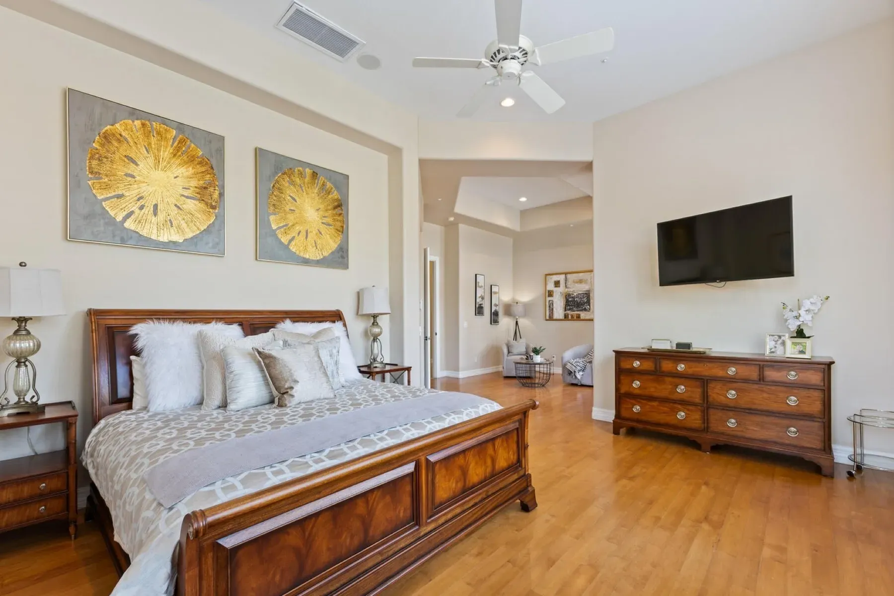Warm bedroom with hardwoods and a big bed. Easy to nap here.