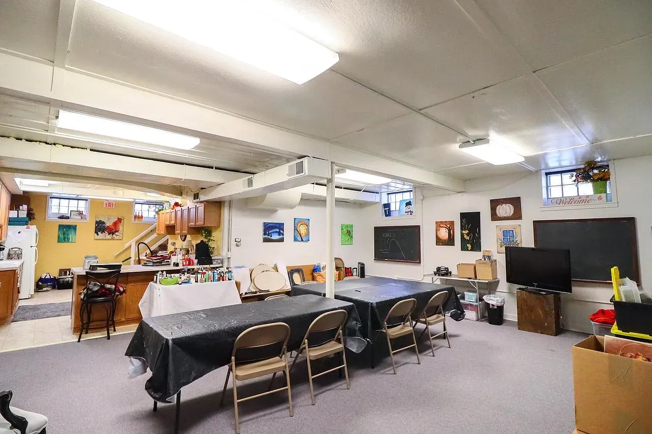 Big flex space with earthy walls and exposed beams. Casual, a little industrial.