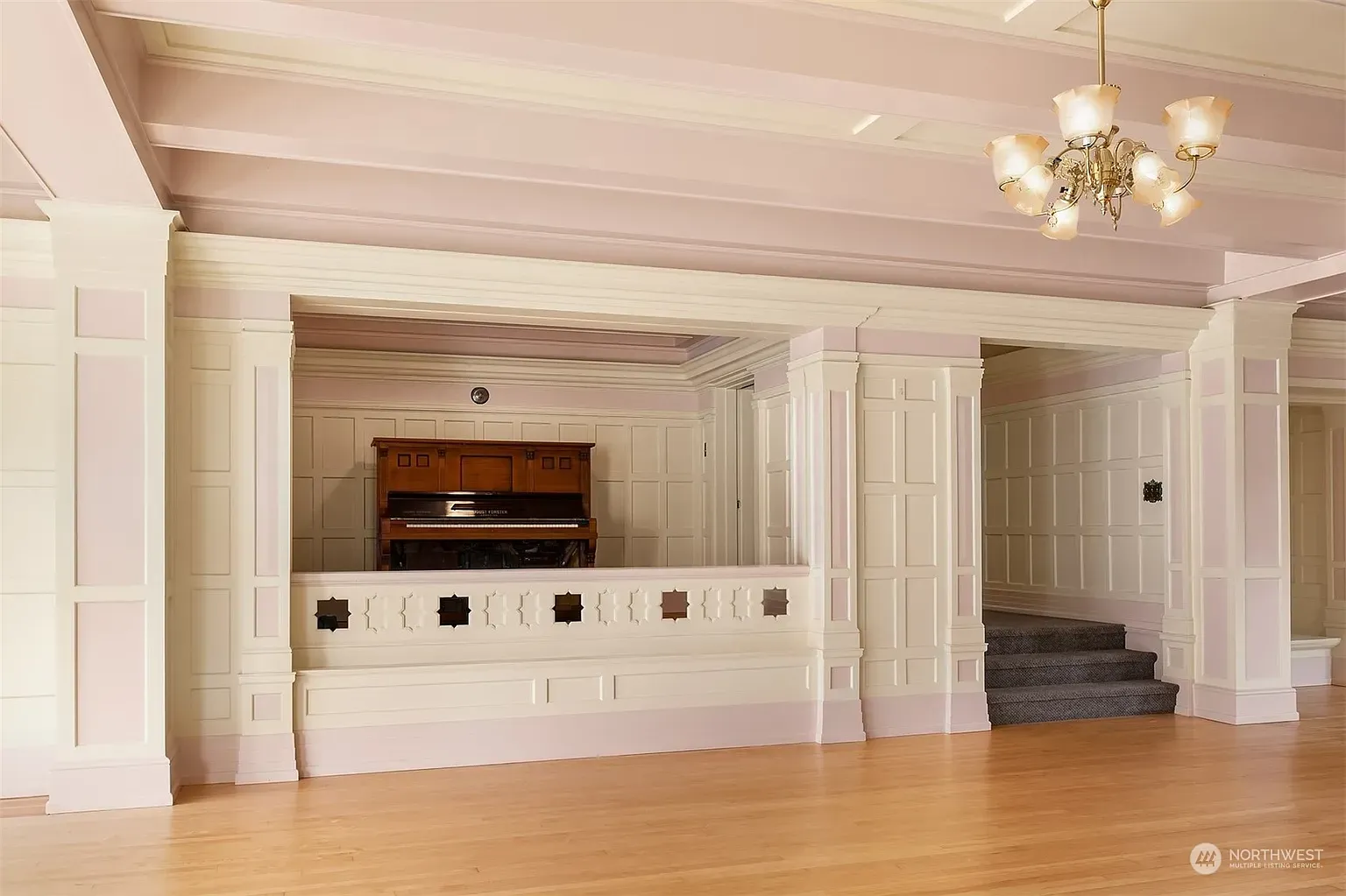 Soft pink walls with crisp wainscoting. Sweet without going full cotton candy.