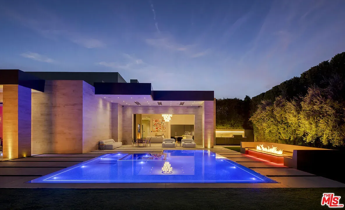 Night pool glowing electric blue, very resort, clean angles everywhere.