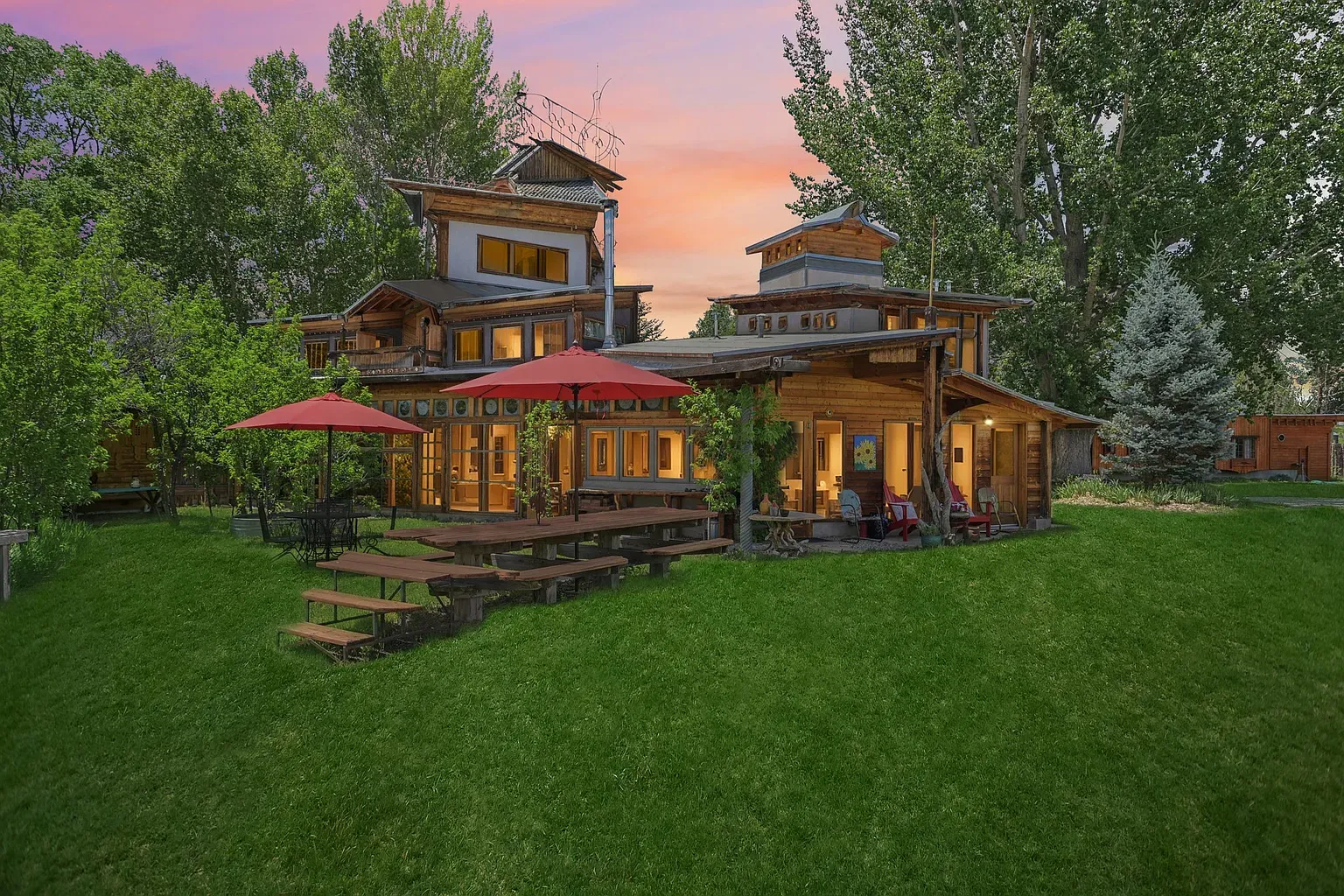 Multi-level exterior, natural wood, warm browns and greens—cozy treehouse energy without the tree.