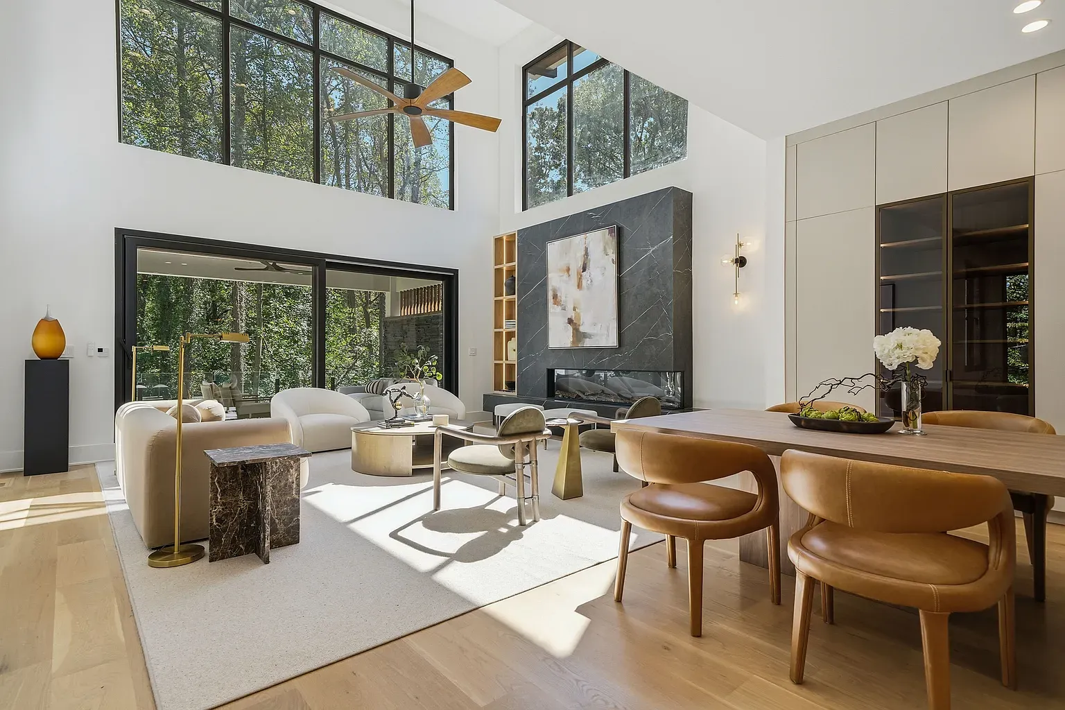 Open living with those massive windows. Ceiling height makes the sofa look tiny.