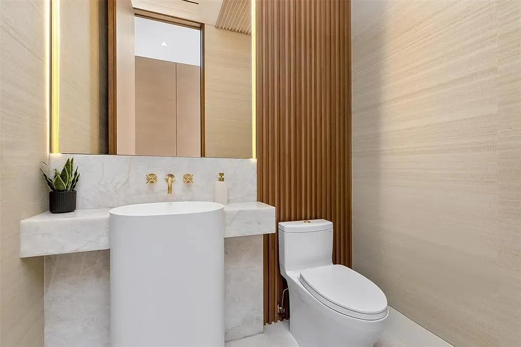 Minimal bath—creamy walls, chunky marble sink. Clean without feeling cold.