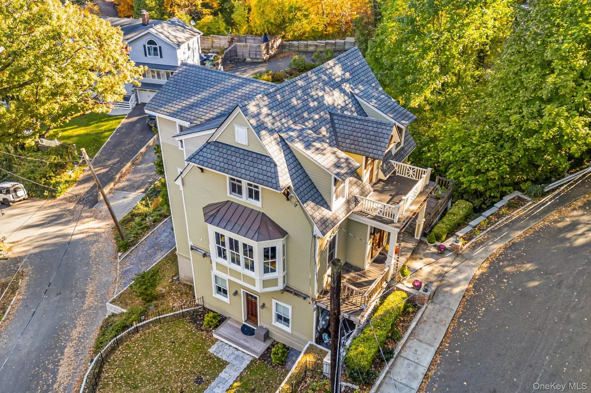 Cream exterior with slate gables on a slope. big windows, very stately.