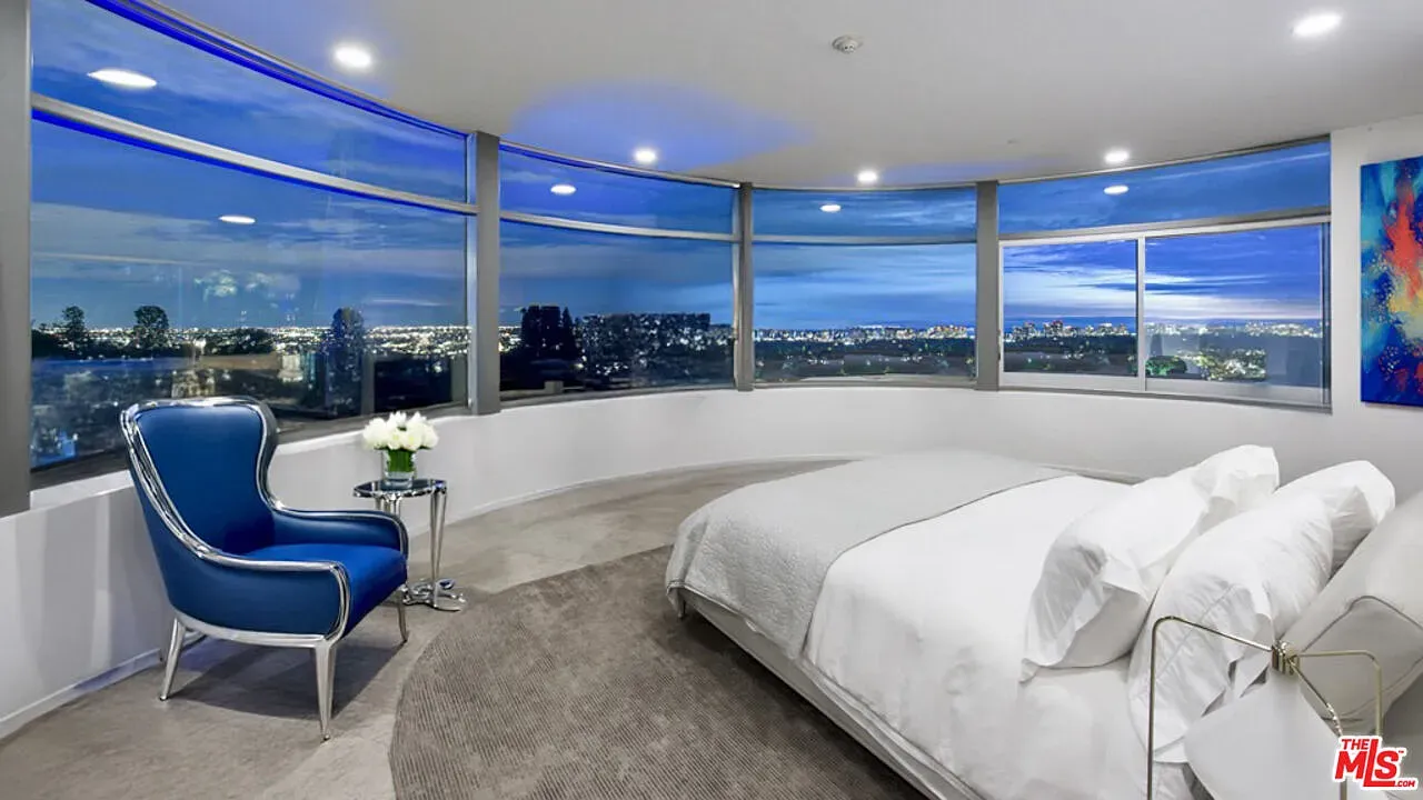 Bedroom wrapped in glass. City and water views doing the lullaby.