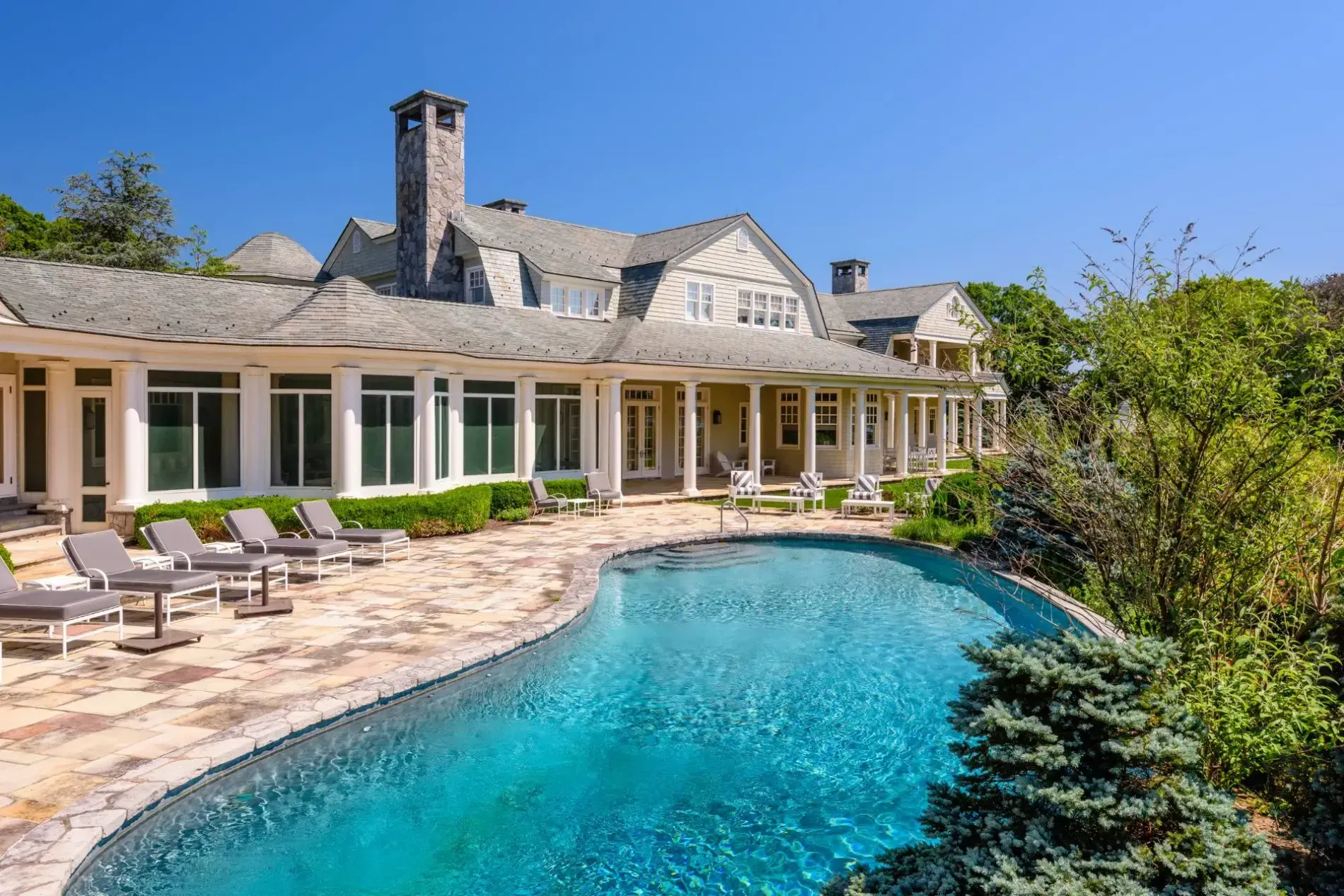 Back outside—clear pool, stone deck. I mean, it's dreamy without trying.