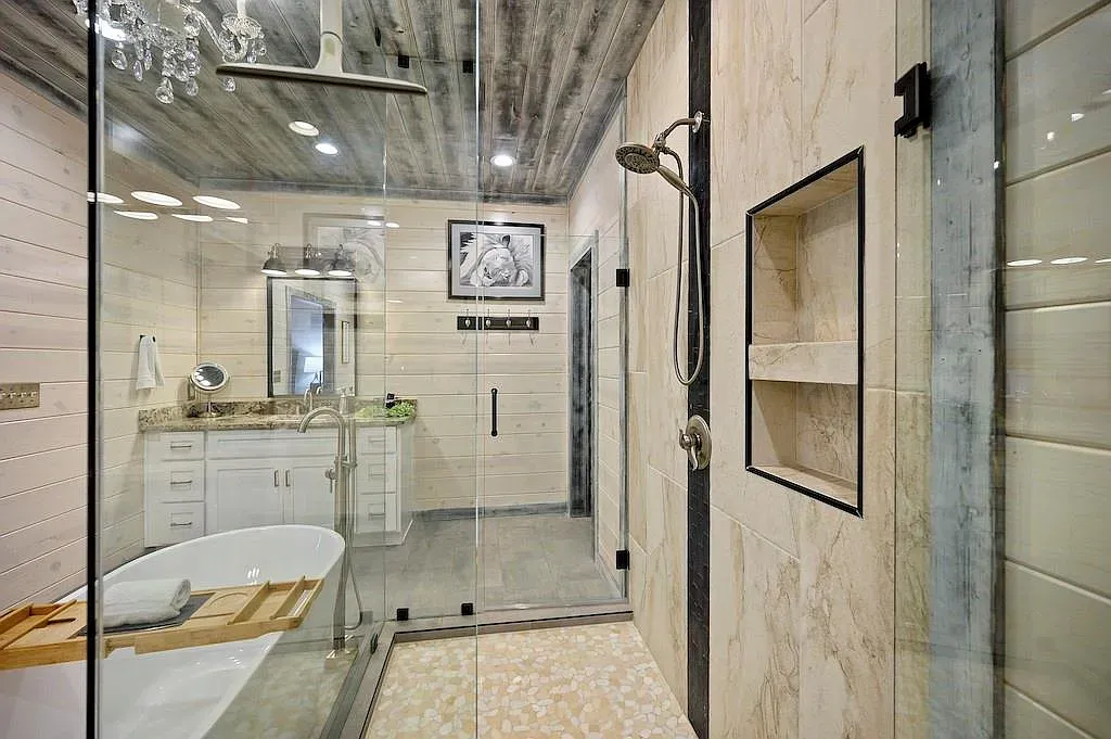 Warm neutral bathroom with big modern finishes. Looks straight from a spa.