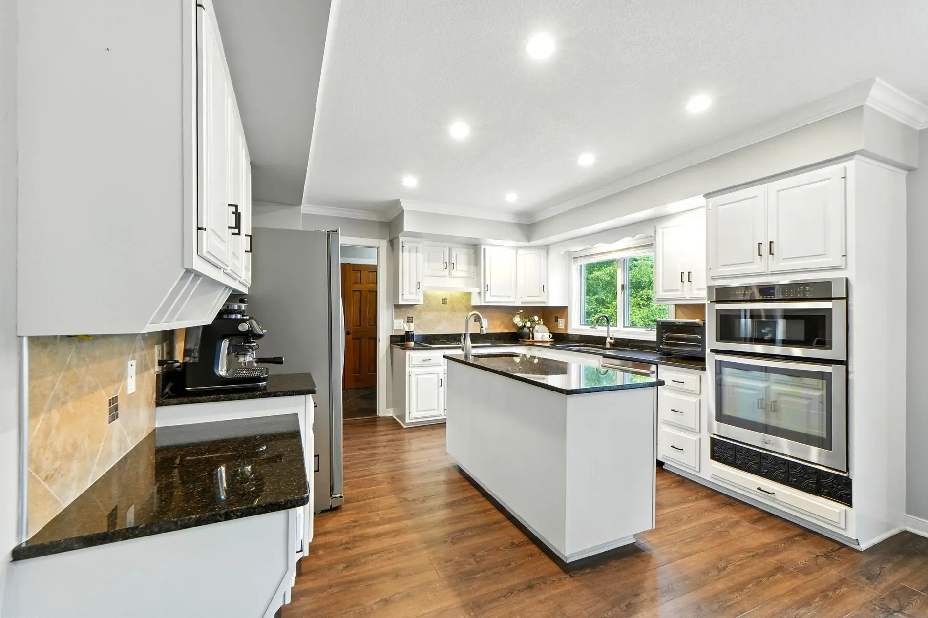 Here’s the kitchen — clean lines, gray and white, black accents. Balanced.