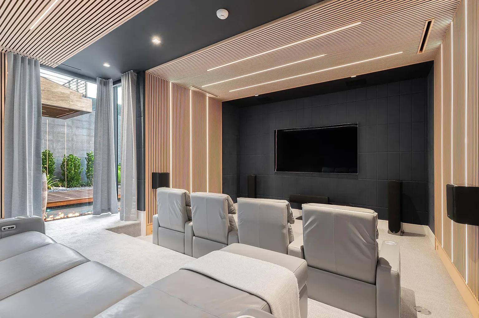 Theater room is moody and minimal. That textured wall eats the sound, right?