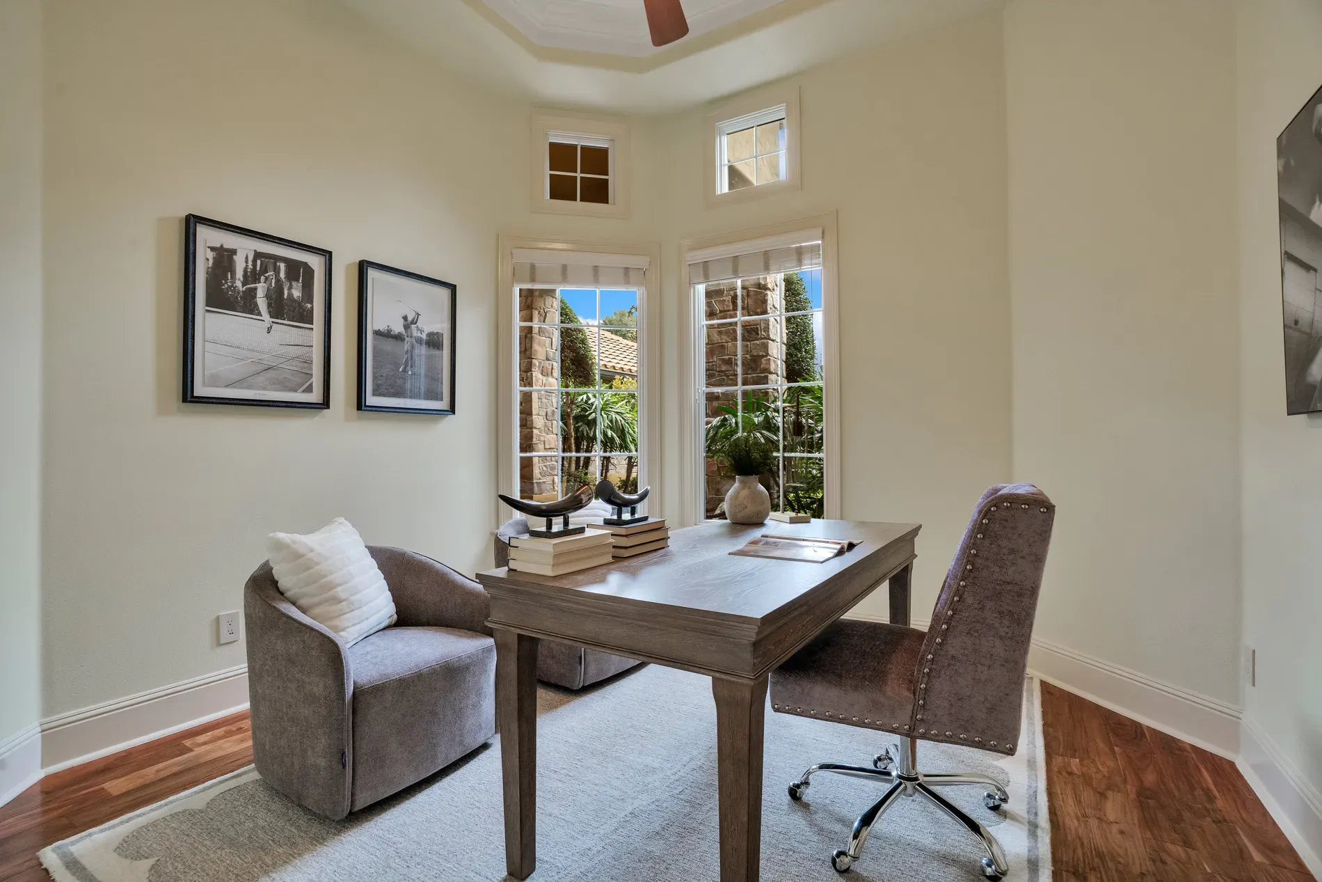 Another office. pale walls, crown molding, gridded windows. Light is doing the work.