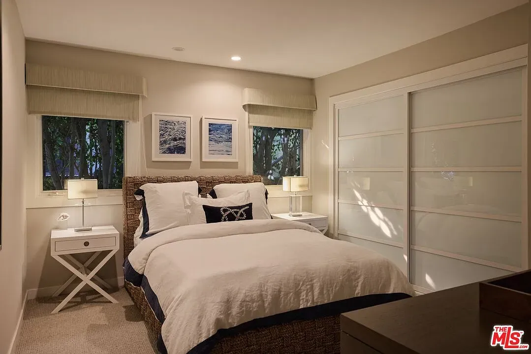 Here's the cozy room—woven headboard with crisp navy piping. Simple, works.