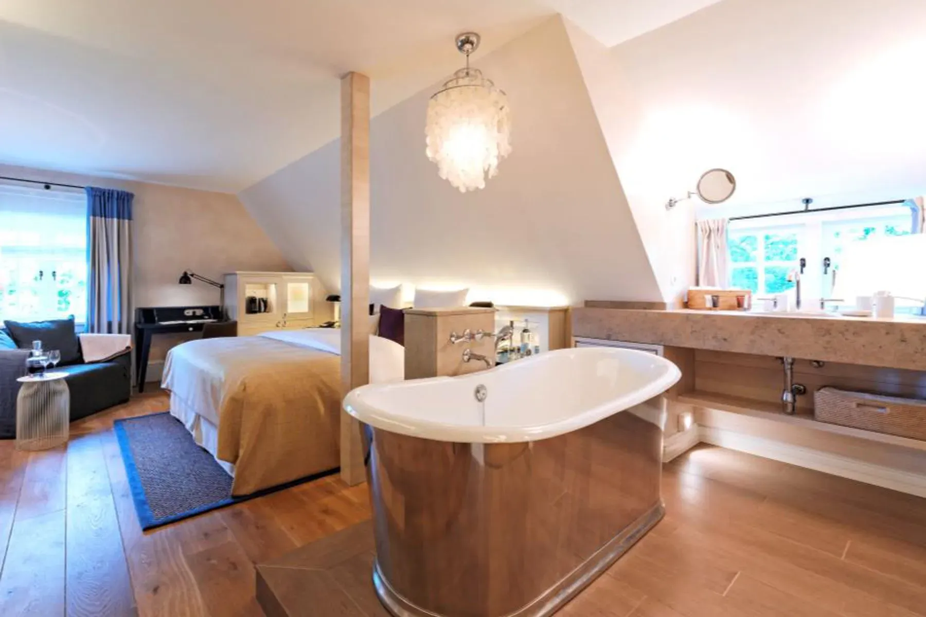 Bedroom and bath open plan, all beige and calm. Spa pajamas zone.