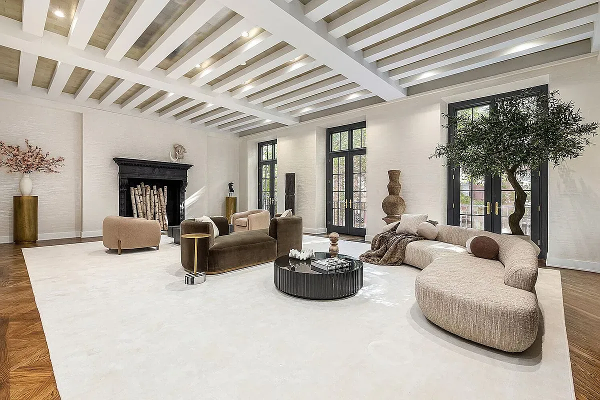 Here’s the big living room—coffered ceiling, warm floors. From this angle, wow.