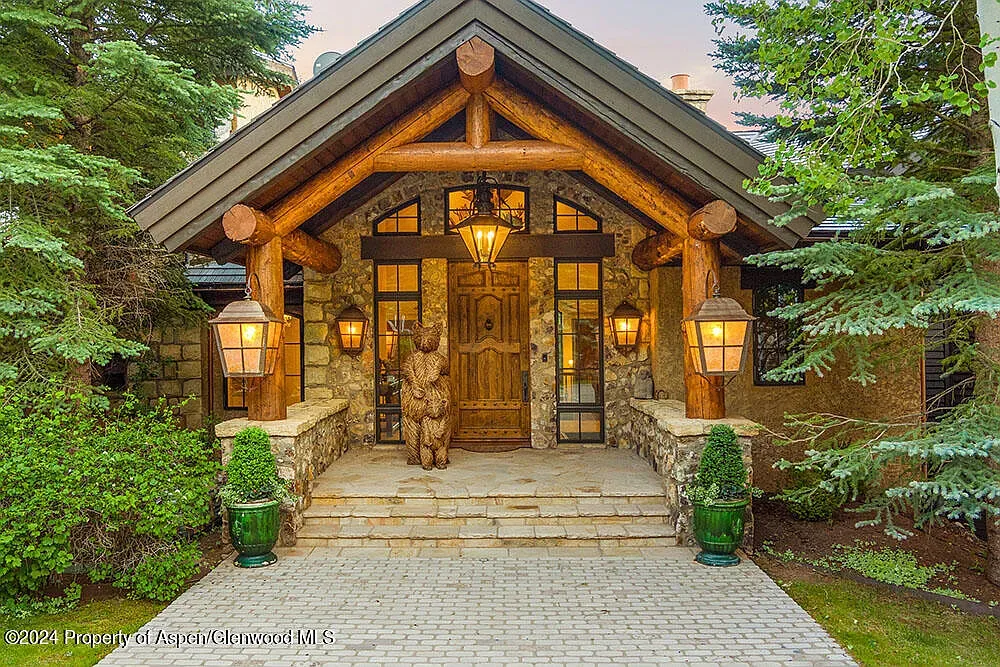 Chunky log columns at the entry. Deep overhang you could hide under.