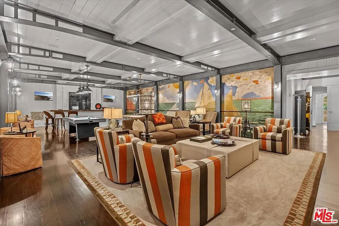 Open living room, high ceilings, white and dark wood playing nicely.