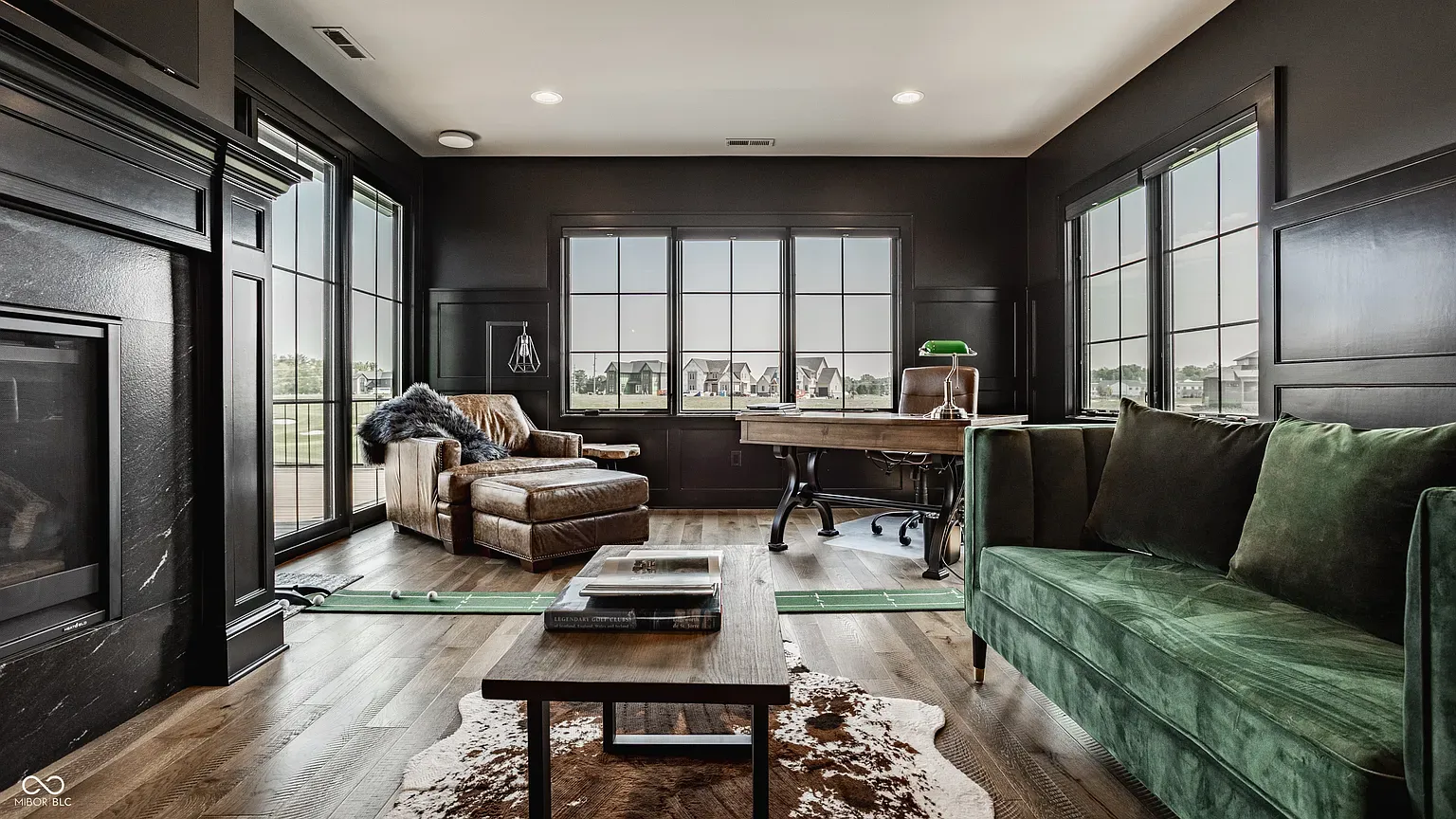 Moody paneled room. Dark walls, big windows, very pour-a-whiskey energy.