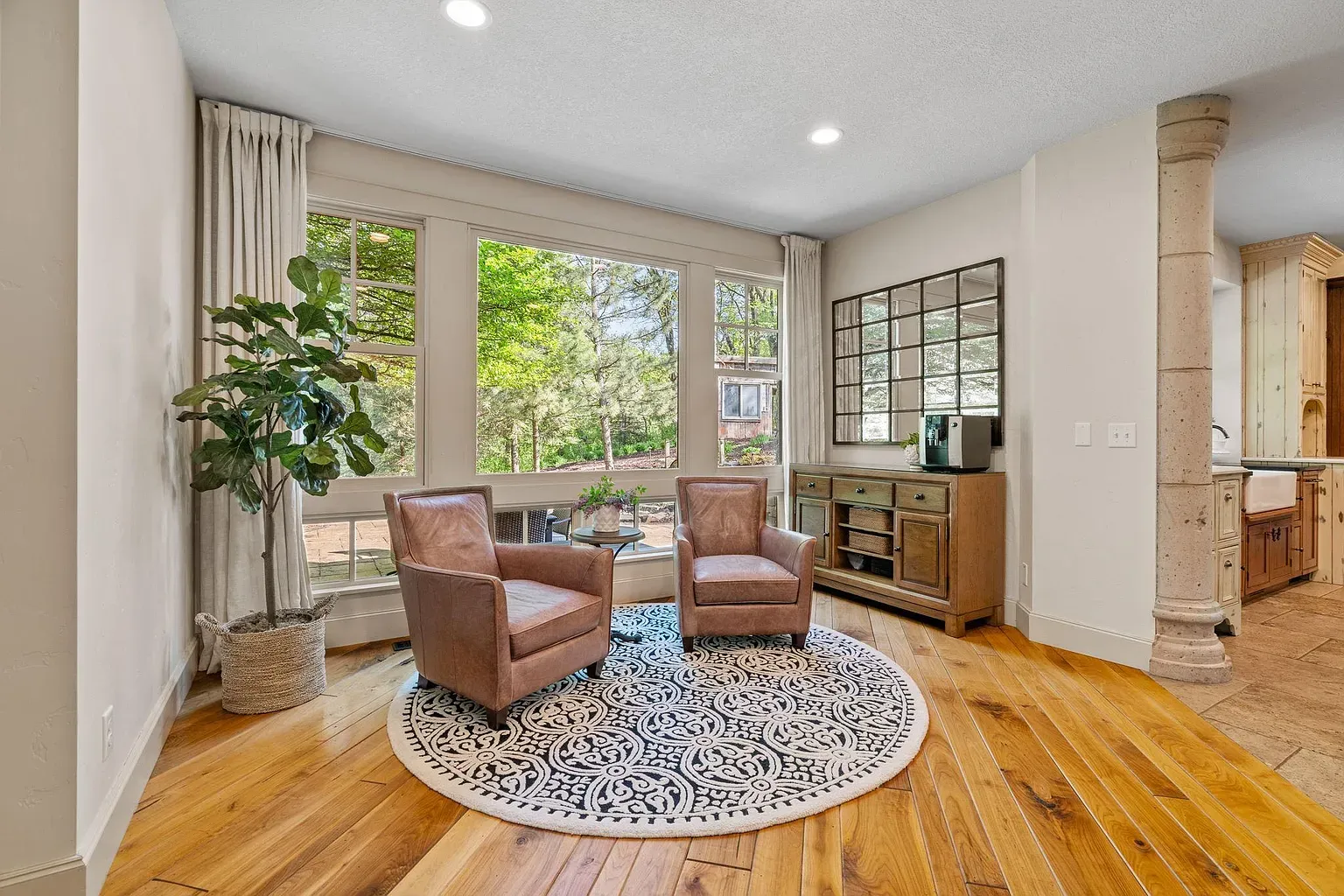 Sunlit corner with trees out the window and warm floors. Easy spot.