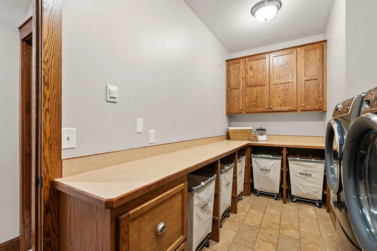 Laundry with real storage and oak cabinets. I'd actually fold clothes here.